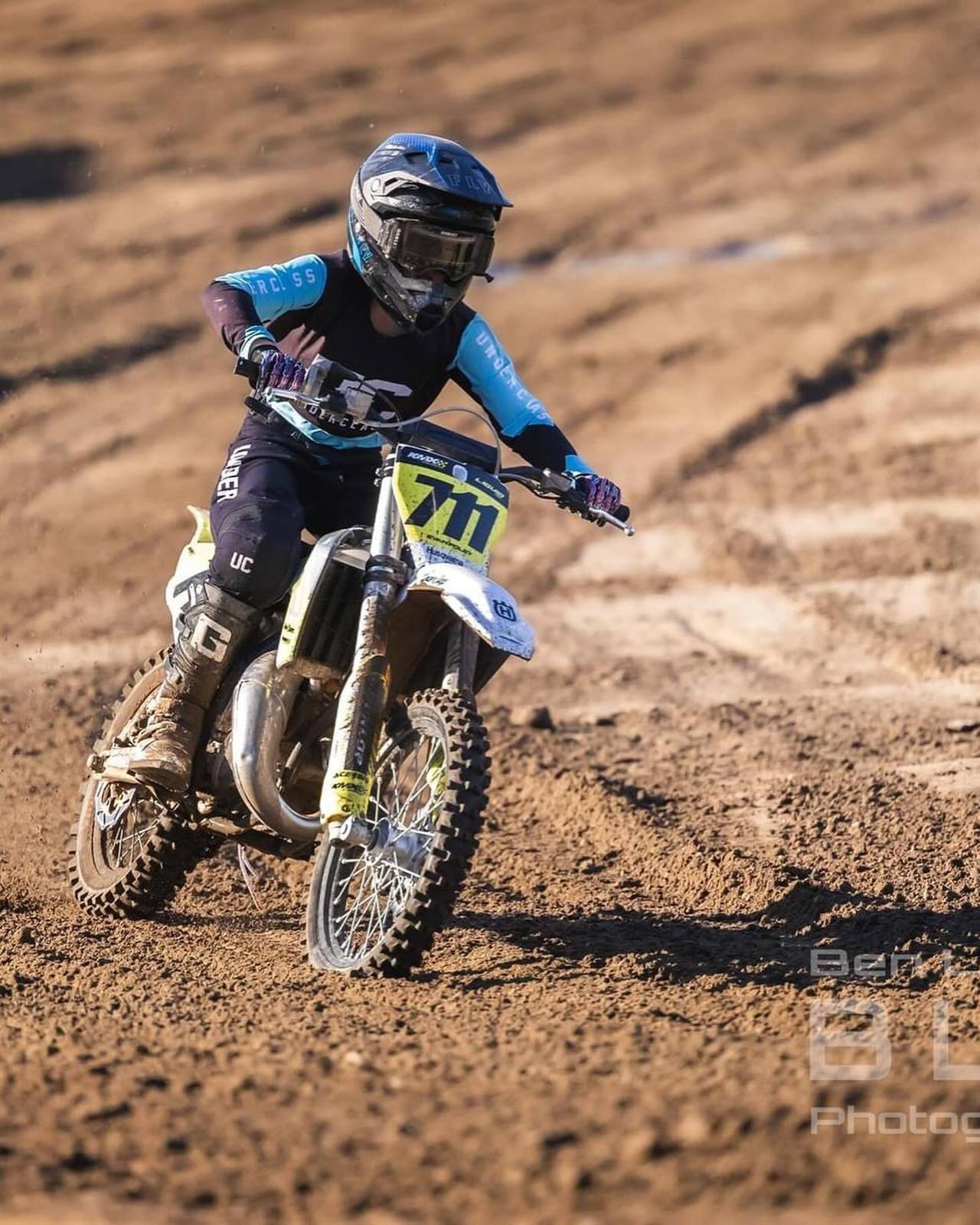 Evan Foley cornering on his motocross bike, race #711